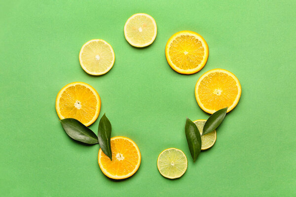 Frame made of cut citrus fruits on color background