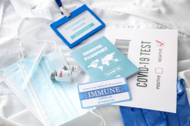 Covid-19 test sonuçları, bağışıklık pasaportu, tıbbi maskeler ve doktor önlüğündeki aşı.