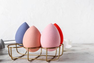 Makyaj süngerleri ve yumurta tutacağı olan yaratıcı kompozisyon, yakın plan