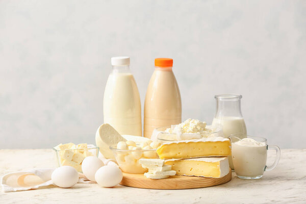 Different dairy products on light background