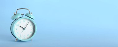 Alarm clock on color background with space for text