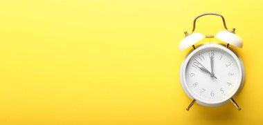 Alarm clock on color background with space for text