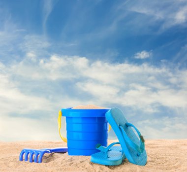 Set of beach accessories for children on sandy beach