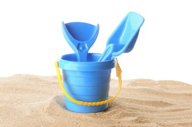 Beyaz arka planda kumdaki çocuklar için plaj oyuncakları.