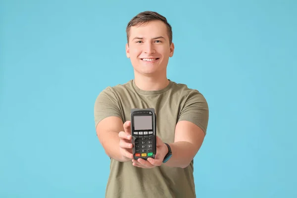 Young Man Payment Terminal Color Background — Stock Photo, Image