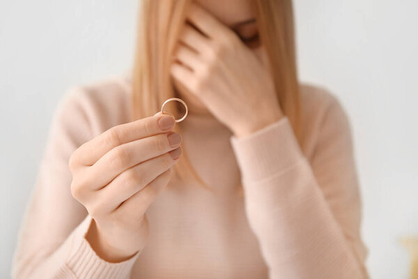 Woman with her wedding ring. Concept of divorce
