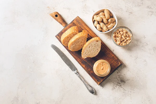 Jar Tasty Peanut Butter Pieces Bread Light Background — Stock Photo, Image