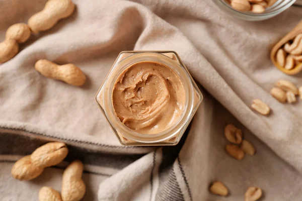Jar Tasty Peanut Butter Fabric Background — Stock Photo, Image