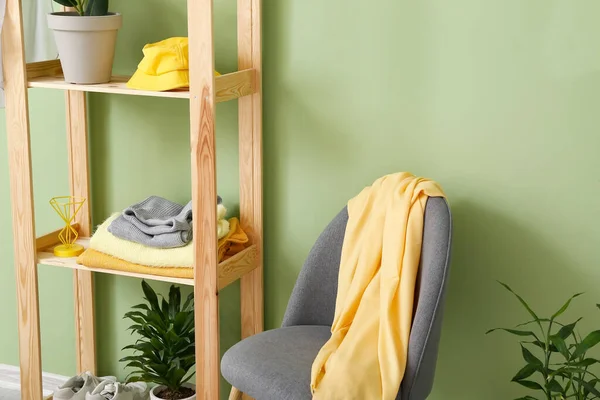 Rack with clothes and chair in dressing room