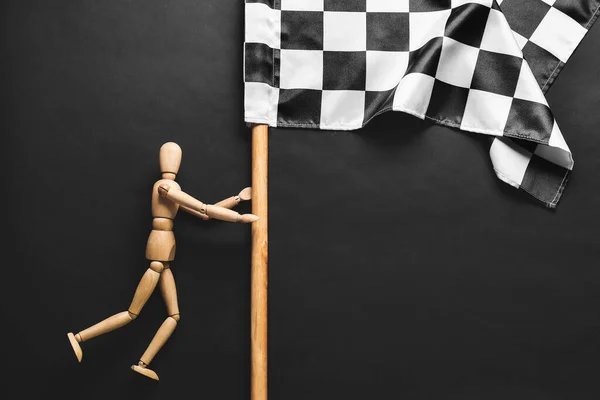 Wooden Mannequin Racing Flag Dark Background — Stock Photo, Image