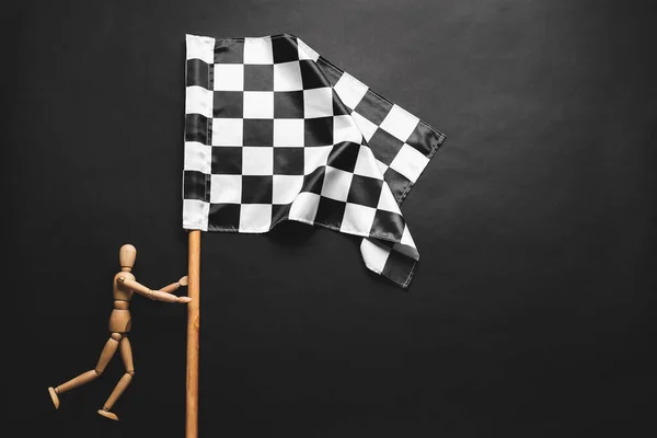 Wooden Mannequin Racing Flag Dark Background — Stock Photo, Image