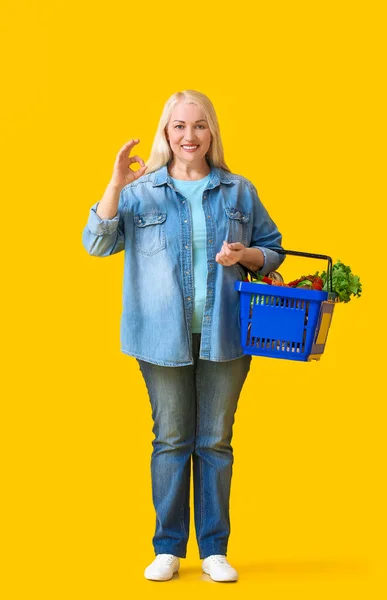 Mature Woman Shopping Basket Showing Color Background — Stock Photo, Image