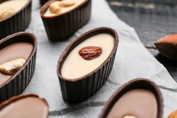 Tasty Chocolate Candies Nuts Baking Parchment Closeup — Stock Photo, Image