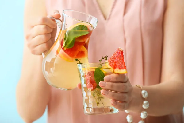 Woman Pouring Tasty Grapefruit Lemonade Jug Glass Color Background — Stock Photo, Image