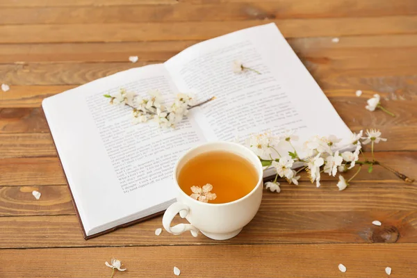 Cup Tasty Tea Book Blooming Branches Wooden Background — Stock Photo, Image