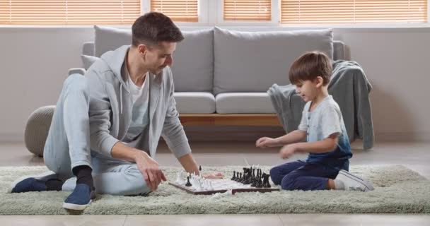 Malý Chlapec Jeho Otec Hrají Doma Šachy — Stock video