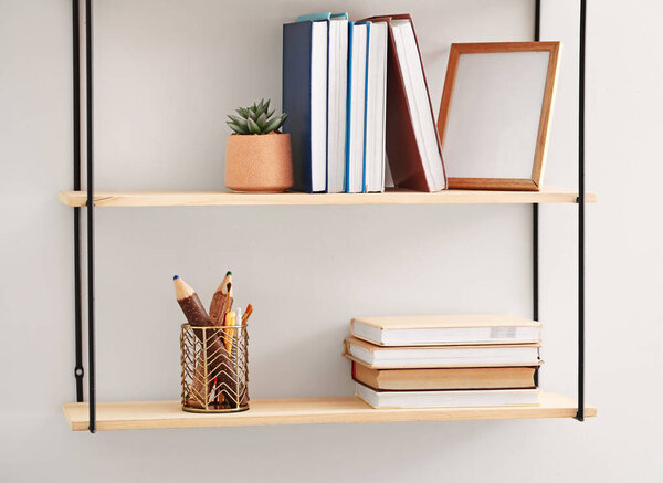 Stylish shelf hanging on light wall
