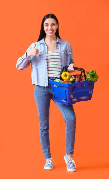 Young Woman Shopping Basket Showing Thumb Color Background — Stock Photo, Image
