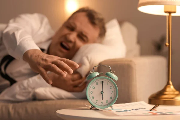 Mature Man Turning Alarm Clock Night — Stock Photo, Image