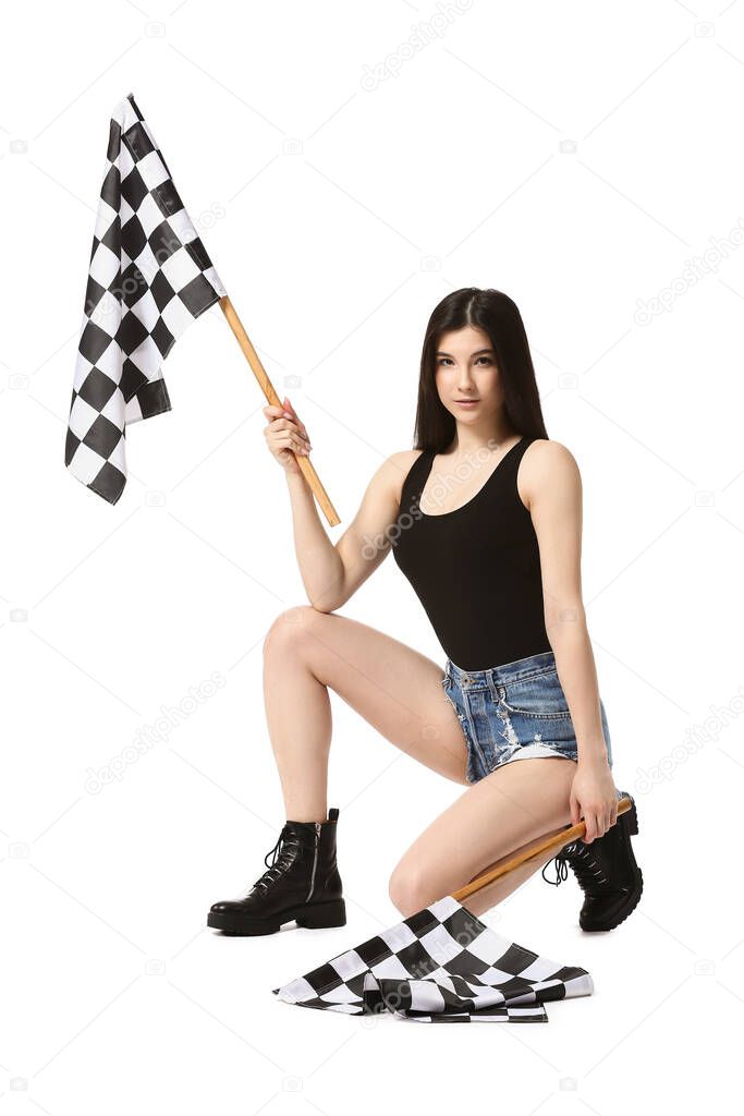 Beautiful young woman with racing flags on white background