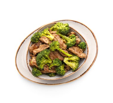 Plate with tasty beef and broccoli on white background clipart