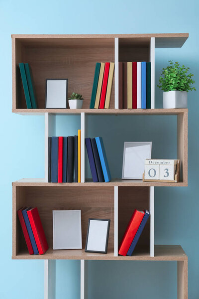 Shelf unit with books near color wall