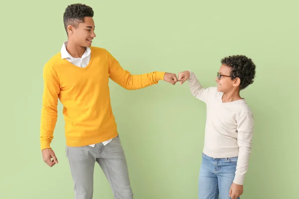 African American Boys Bumping Fists Color Background — Stock Photo, Image