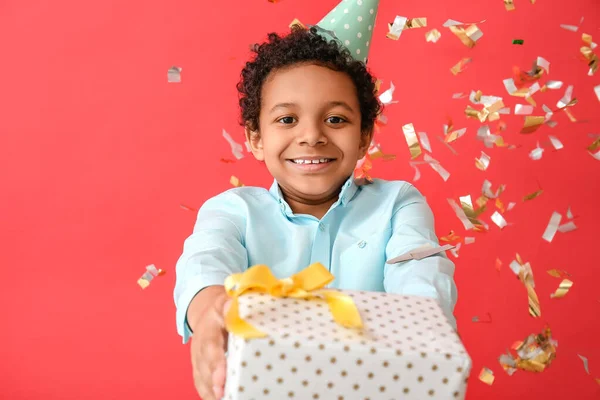 African American Boy Gift Box Falling Confetti Color Background — Stock Photo, Image