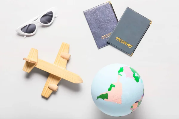Globe Wooden Airplane Sunglasses Passports Light Background —  Fotos de Stock