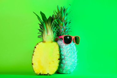 Renkli güneş gözlüklü tonlarca taze ananas.