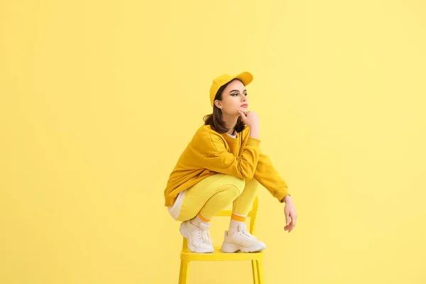 Stylish Young Woman Sitting Chair Yellow Background — Foto de Stock