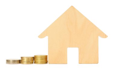 Beyaz arka planda bozuk paraları olan ev figürü