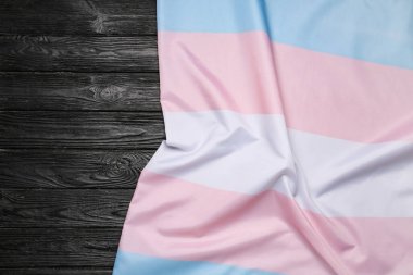 Transgender flag on dark wooden background clipart