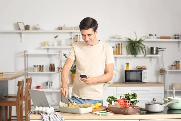 Young Man Taking Photo Baked Fish Vegetables Kitchen — Stock Photo, Image