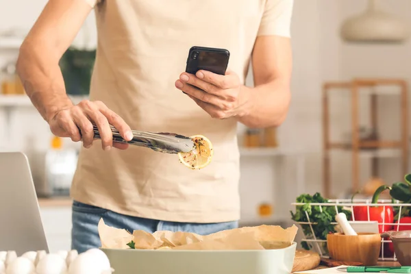 Young Man Taking Photo Baked Fish Lemon Kitchen — Stock Photo, Image