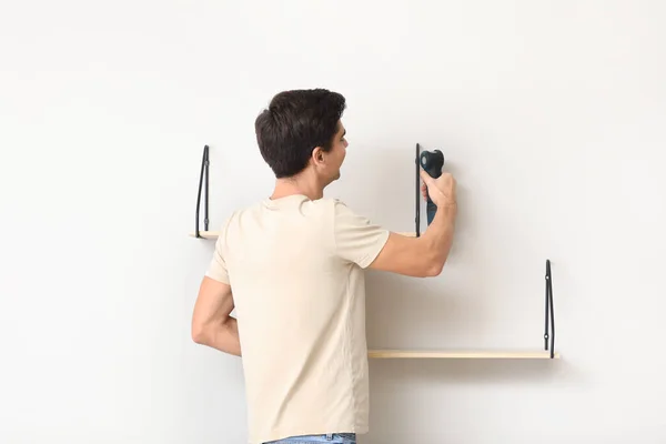 Young Man Installing Modern Shelves Room — Foto de Stock