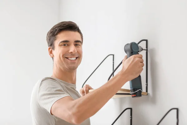 Young Man Installing Modern Shelf Room — Stock Photo, Image