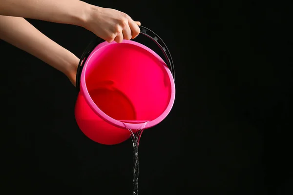 Woman Pouring Water Bucket Dark Background —  Fotos de Stock