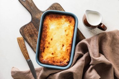 Hafif arka planda lezzetli süzme peynirli güveç.