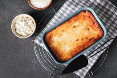 Koyu arkaplanda lezzetli süzme peynirli güveç.