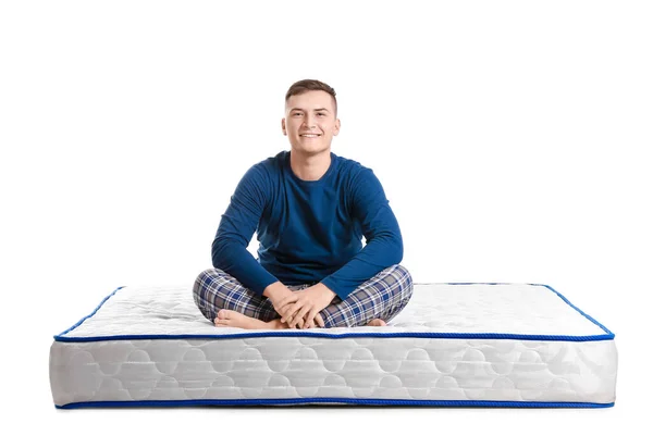 Young Man Sitting Soft Mattress White Background —  Fotos de Stock