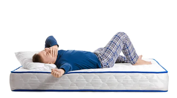 Young Man Lying Soft Mattress White Background — Stock Photo, Image