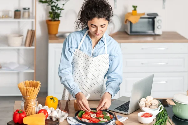 Young Woman Putting Basil Pizza Home — Stock Photo, Image
