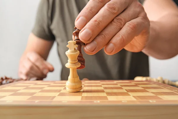 Man Playing Chess Light Background Closeup — Stock Photo, Image