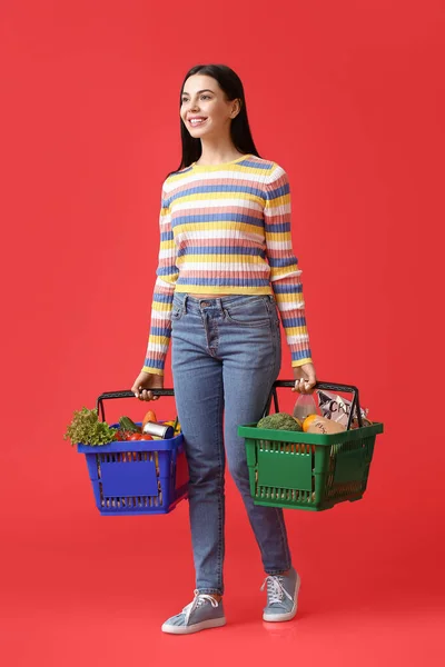 Young Woman Shopping Baskets Color Background — Stock Photo, Image