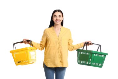 Young woman with shopping baskets on white background