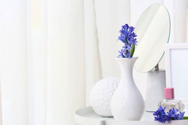 Beautiful composition with hyacinth flowers on table at home