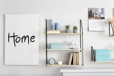 Shelves and picture hanging on light wall in room