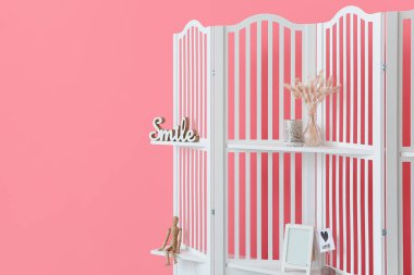 Modern folding screen with decor near color wall