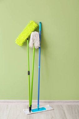 Floor mops near color wall
